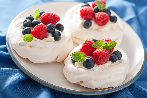 istock pavlova meringue cake with cream and berry 504485343
