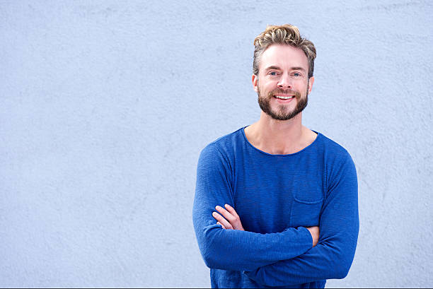 istock Confident guy smiling with arms crossed 504485578