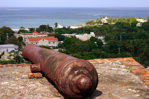 Canon looking towards Vieques, Isabel Segunda harbor. Placed on top of a red brick wall. Top right Punta Mulas lighthouse.  Late Spanish fortress.