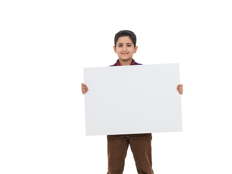 Little boy holding placard his looking for camera with a happy facial exppressions.,studio shot.Image taken with medium format Hasselblad H3D camera system and developed from camera RAW.