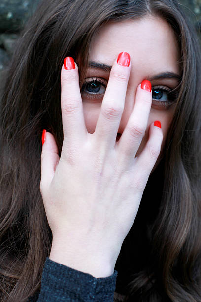 istock Beautiful young woman looking through her fingers 504488738