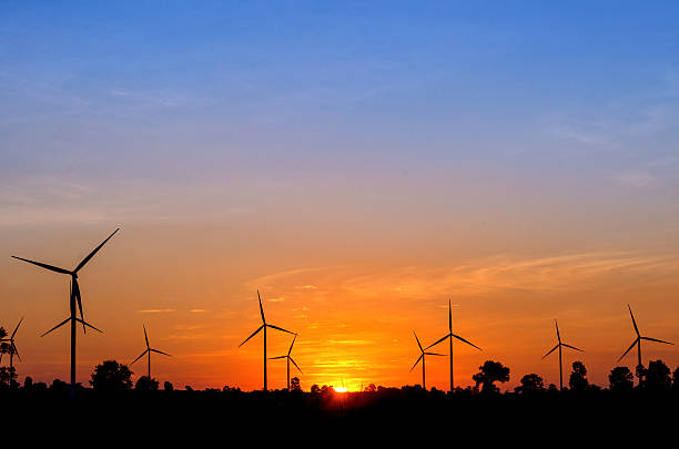 istock Eco power in wind turbine farm with sunset 504491010