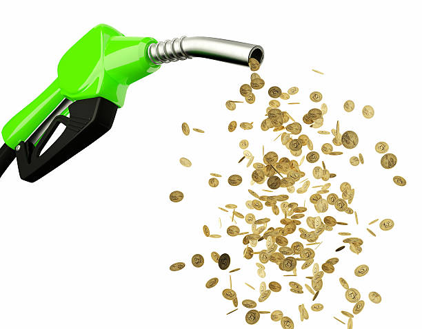 istock Fuel nozzle pouring Dollar coins isolated on white background 504493362