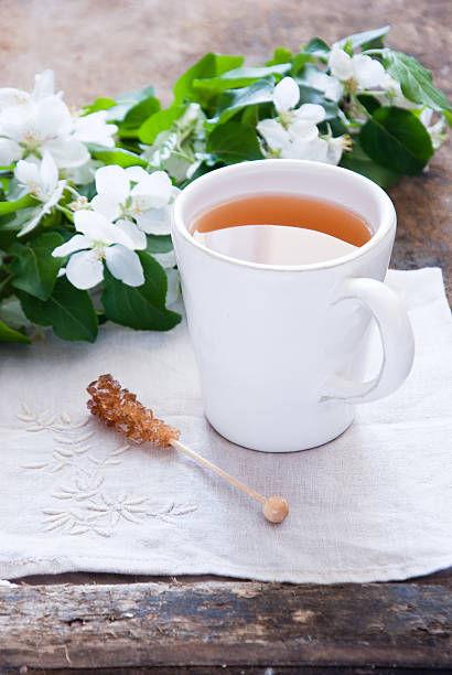istock Cup of green tea and blossom 504506793