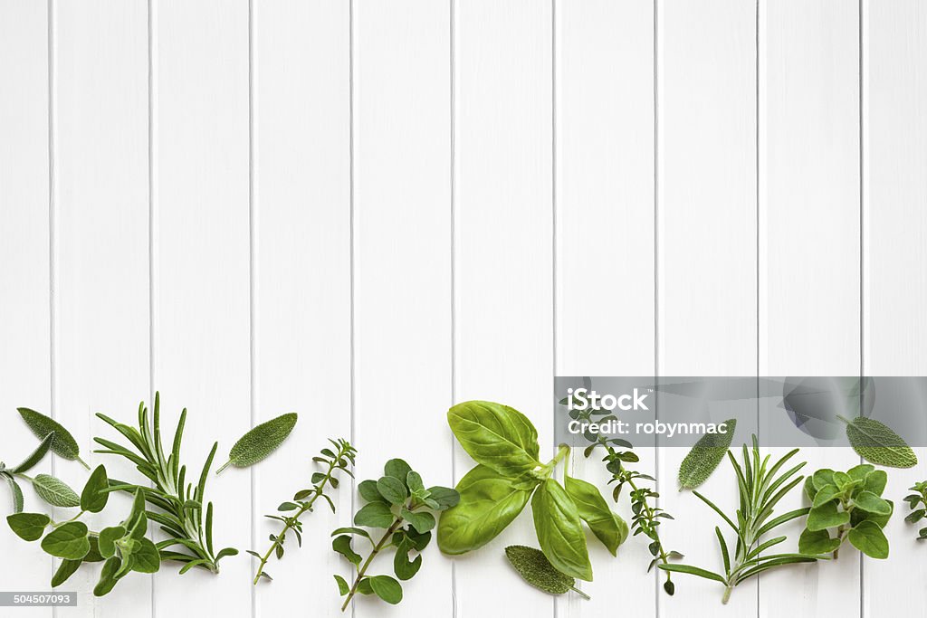 Fresh Herbs Border Fresh herbs border over white timber panel background. Backgrounds Stock Photo