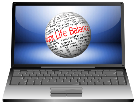 laptop with work life balance wordcloud on blue desktop
