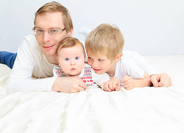 istock father with infant daughter and little son 504509191