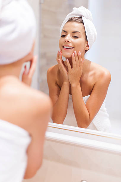 istock Woman looking on reflection in the mirror after shower 504509321