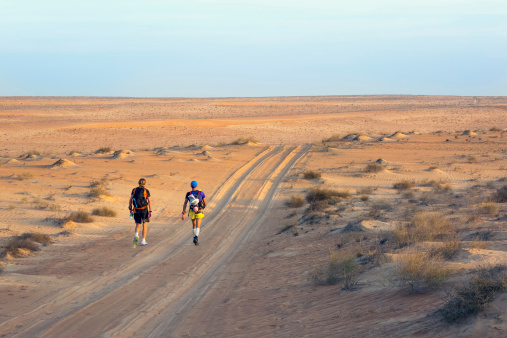 Wahiba Desert, Oman - January 29, 2014: Winners of the most extreme endurance marathon Transomania 2014, Joao Oliveira and Johan Steene, evening before arriving to the finish point, on January 29, 2014.