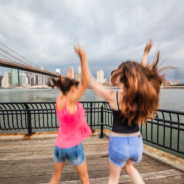 istock Two girls, sisters, looking to Manhattan under thunderstorm 504511599