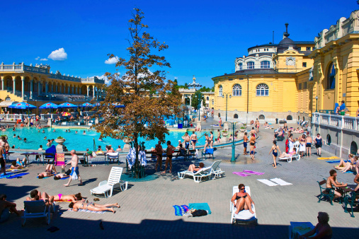 Budapest, Hungary - July 10, 2012: People have a thermal bath in the Szechenyi spa. Szechenyi Medicinal Bath is the largest medicinal bath in Europe.