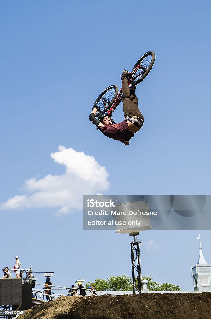 Upside down with a bike Quebec, Canada - July 30, 2014: Stunt cyclist jumping upside down during a free and public outdoor competition downtown Quebec city. Bicycle Stock Photo