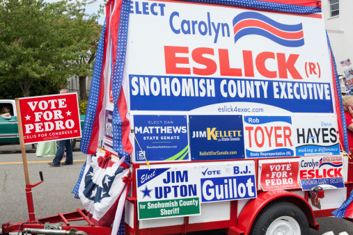 Everett, United States - July 4, 2014: This image shows a float that was part of the 4th of July Parade in downtown Everett, Washington. The float has signs for a variety of local Snohomish County candidates for office including Carolyn Eslick, Dan Matthews, Jim Kellett, Rob Toyer, Jim Upton, and B.J. Guillot. The float is parked on the street in downtown Everett.