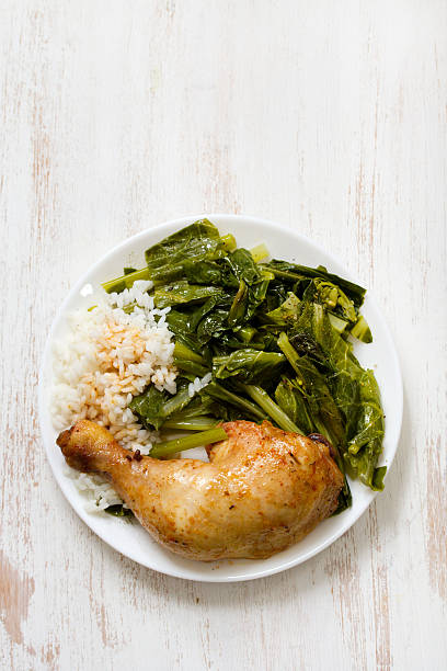 istock fried chicken with rice and vegetables on plate 504522136