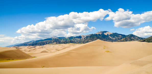 Springtime in Great Sand Dunes National Park, Colorado, USA, with Medano Creek flowing at the base of sand dunes.