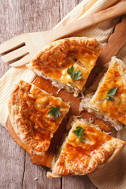 istock chicken pie sliced closeup on the table. vertical top view 504523880