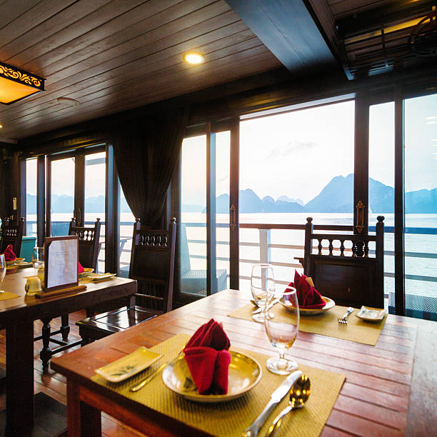 Cruise ship restaurant table  with view of Halong Bay Vietnam Cruise ship set restaurant table  with view of Halong Bay, Vietnam. gulf of tonkin photos stock pictures, royalty-free photos & images
