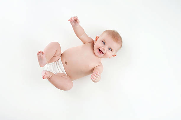 Laughing Baby Girl A laughing four month old baby girl wearing a white diaper cover. Shot from overhead on a white background. blue eyes photos stock pictures, royalty-free photos & images