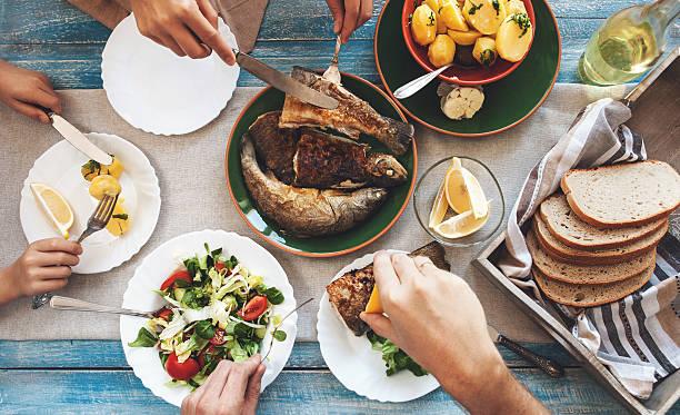 istock Family dinner with fried fish, potato and salad 504526288