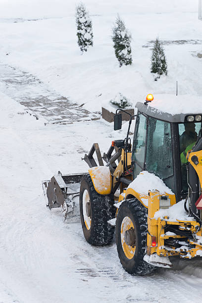 istock Tractor shoveling snow on the street. Space for your text. 504526564