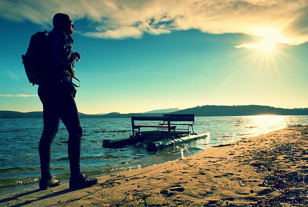 istock Tall tourist walk on beach at paddle n the sunset 504527108