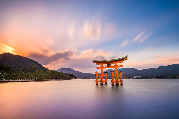 Miyajima, Hiroshima, Japan Hiroshima, Japan - December 3, 2015: The Floating Tori Gate of Itsukushima Shrine off the coast of Miyajima Island. The shrine dates from the mid-16th century. shinto stock pictures, royalty-free photos & images