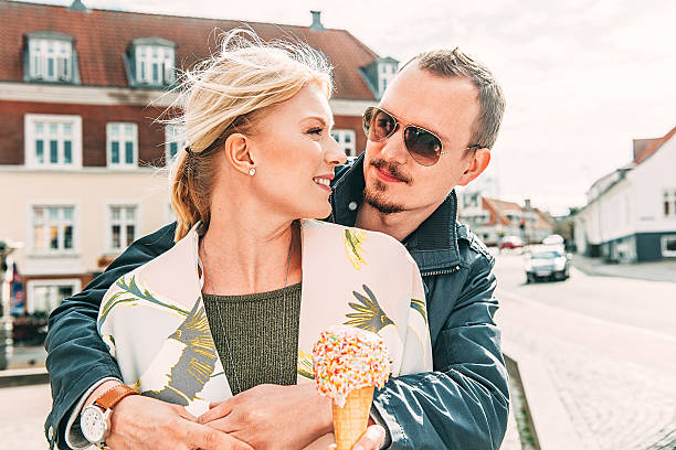 Cute young couple outdoors eating ice cream