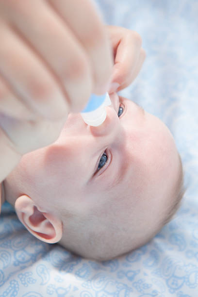 istock Mother using baby nasal aspirator 504530086