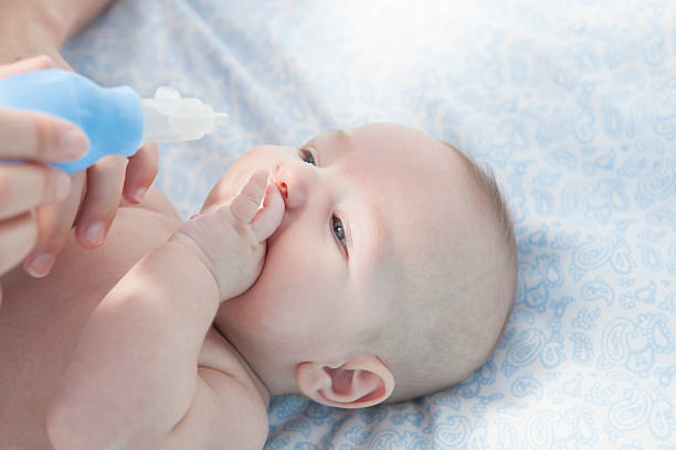 istock Mother using baby nasal aspirator 504530132
