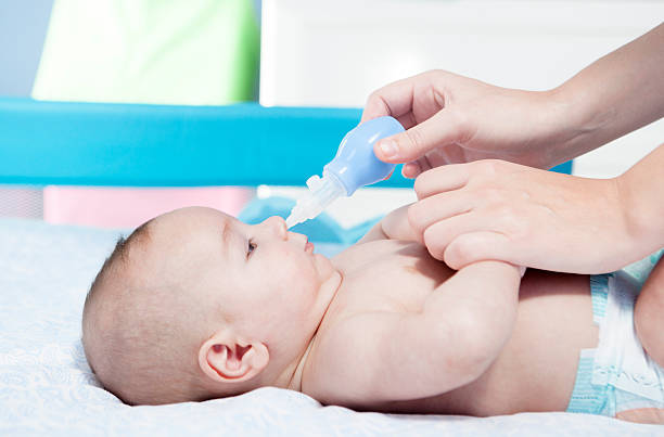 istock Mother using baby nasal aspirator 504530160