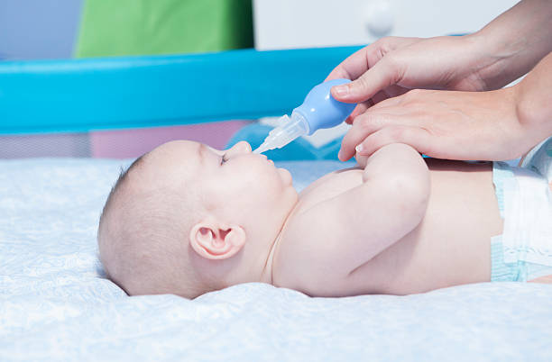 istock Mother using baby nasal aspirator 504530290