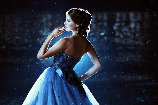 Beautiful lady in blue dress Beautiful lady in blue dress walking near sea prom dress stock pictures, royalty-free photos & images