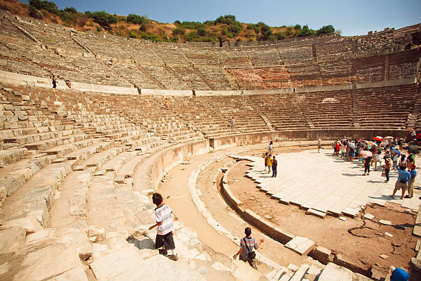 Ephesus: Ancient amphitheatre in historical Ephesus city ruins on cloudy sky in Izmir, Turkey.