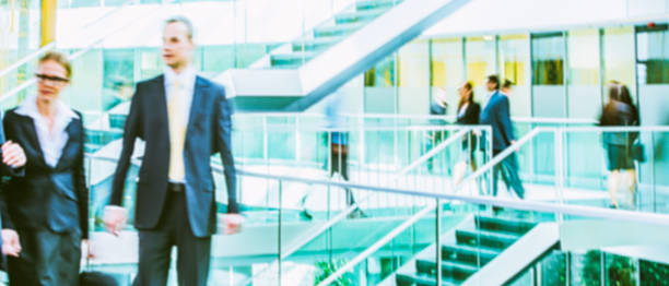 istock Businesspeople walking in office corridor, blurred motion 504535284