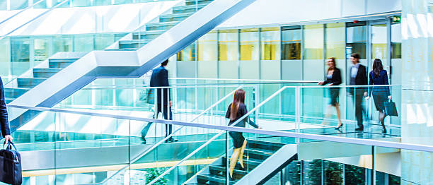 istock Businesspeople walking in office corridor, blurred motion 504535440