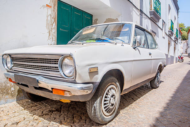 istock Old-fashioned white car ina village 504536158