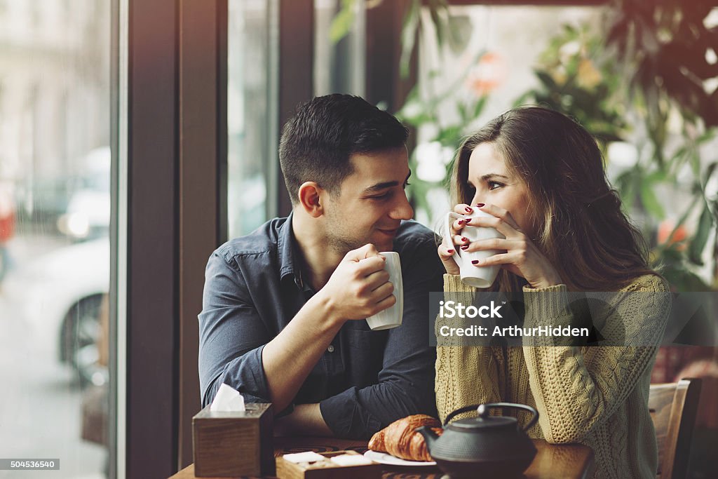Couple in love drinking coffee in coffee shop Couple in love drinking coffee and have fun in coffee shop. Love concepts. Vintage effect style picture Dating Stock Photo