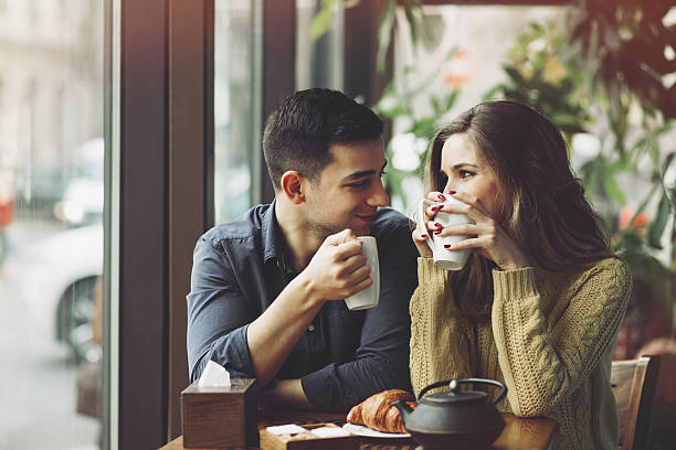 Couple in love drinking coffee in coffee shop stock photo