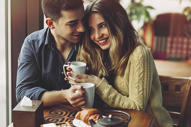 Couple in love drinking coffee in coffee shop stock photo