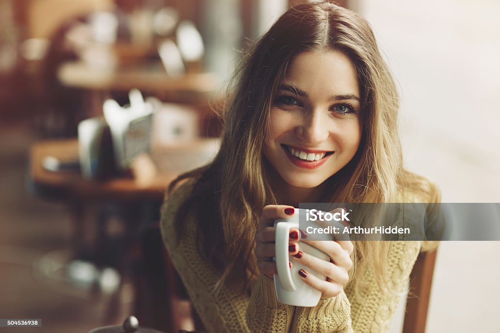 Charming girl drinking cappuccino and eating cheesecake charming girl drinking cappuccino and eating cheesecake in coffee shop Women Stock Photo