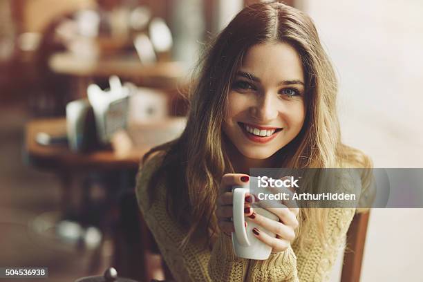 Charming Girl Drinking Cappuccino And Eating Cheesecake Stock Photo - Download Image Now