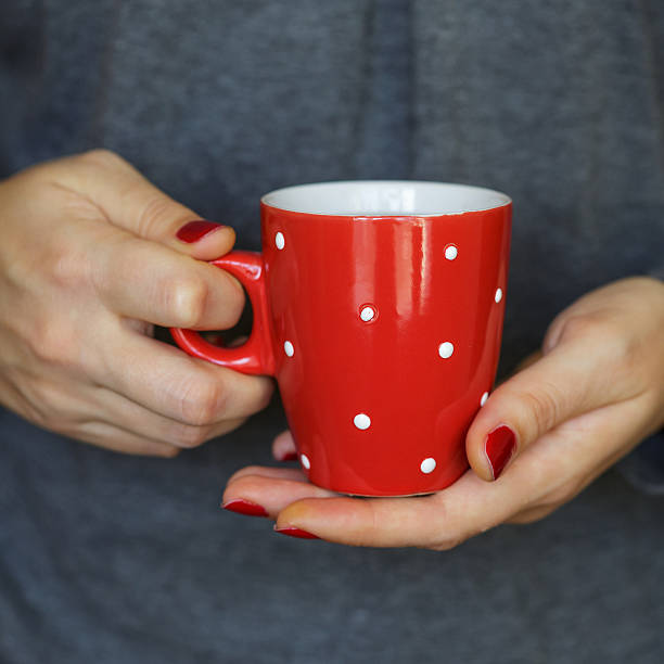 istock Woman hands holding a cozy red mug 504537278