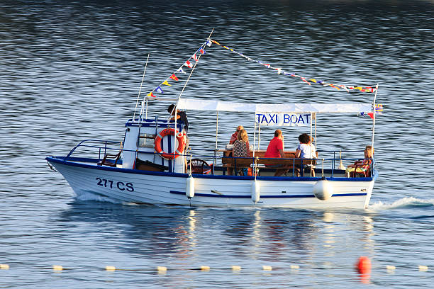 Cres, Croatia - July 14, 2014: People use a water taxi to get into the local town by day or night. The water taxi operates between the campsite and Cres city.