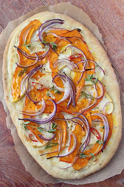 Pizza with pumpkin,apple and red onion.