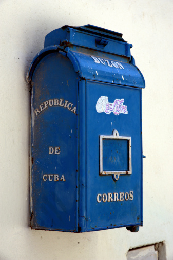 Havana, Cuba, May 8, 2011: A weathered blue mailbox in central Havana, Cuba. A faded advertisement for a drink called 'Cuba Libre' - modeled on the Coca Cola logo, is seen on the front of the mailbox.