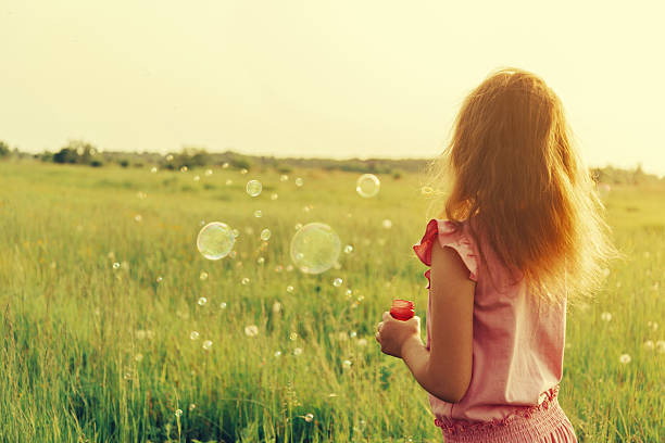 child with short hair in red clothes in the park