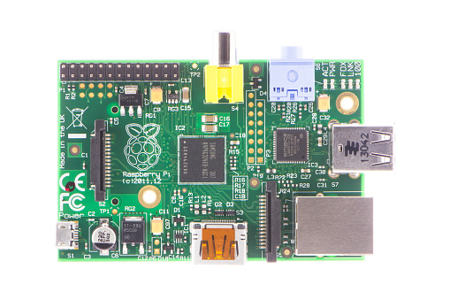 Arad, Romania - May 28, 2014: Raspberry Pi Model-B Rev2. The Raspberry Pi is a credit-card-sized single-board computer developed in the UK by the Raspberry Pi Foundation. Studio shot, isolated on white background.