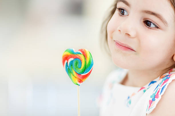 istock Little girl with lollipop 504541099