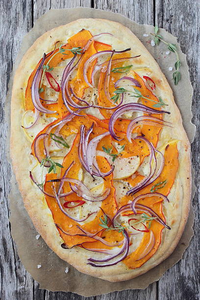 Pizza with pumpkin ,apple and red onion