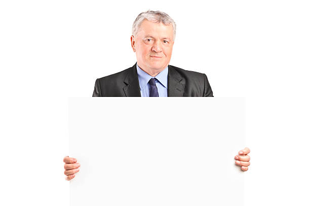 istock Mature businessman holding a blank poster 504542855